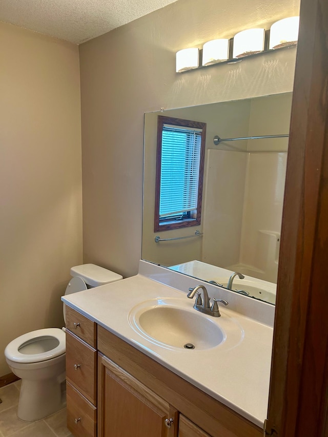 bathroom with walk in shower, tile patterned flooring, a textured ceiling, toilet, and vanity