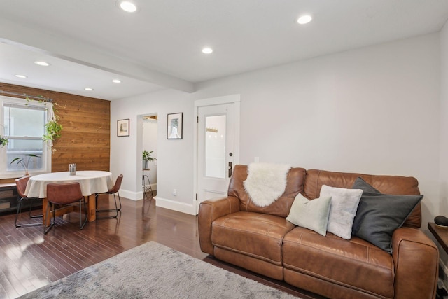 living room featuring dark hardwood / wood-style flooring and beamed ceiling