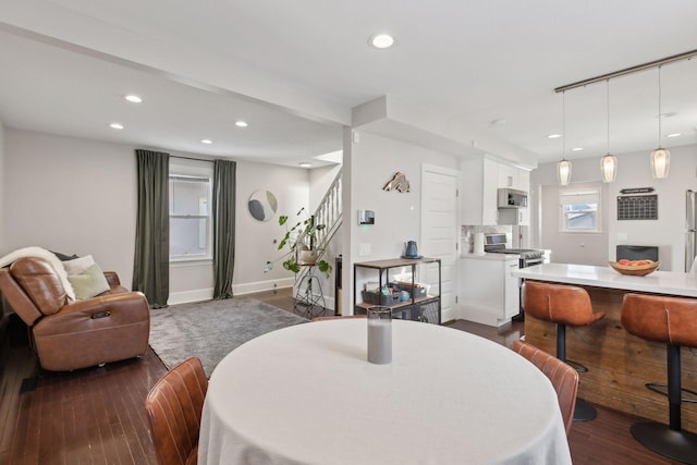 dining area featuring dark wood-type flooring