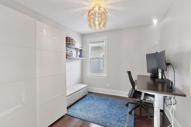 home office featuring a chandelier and dark hardwood / wood-style floors