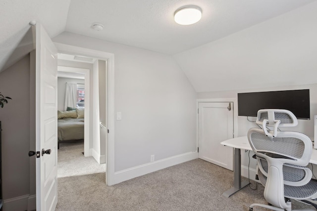 carpeted office with vaulted ceiling