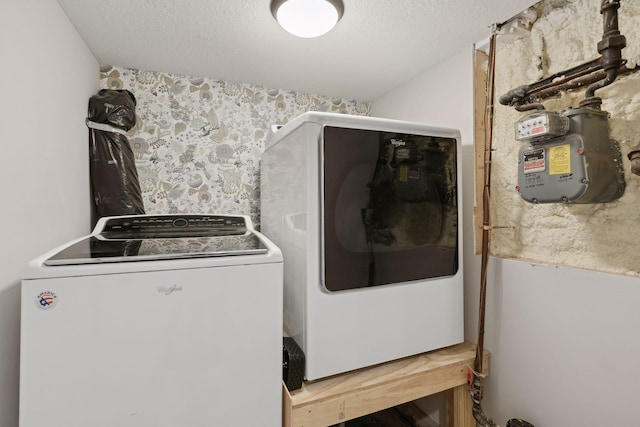 clothes washing area with washer / dryer and a textured ceiling