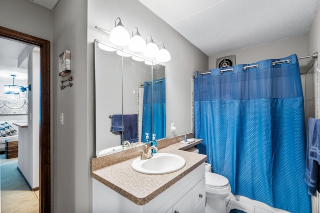 bathroom featuring a shower with shower curtain, a textured ceiling, vanity, and toilet