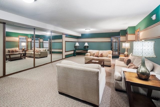 living room featuring carpet and a textured ceiling