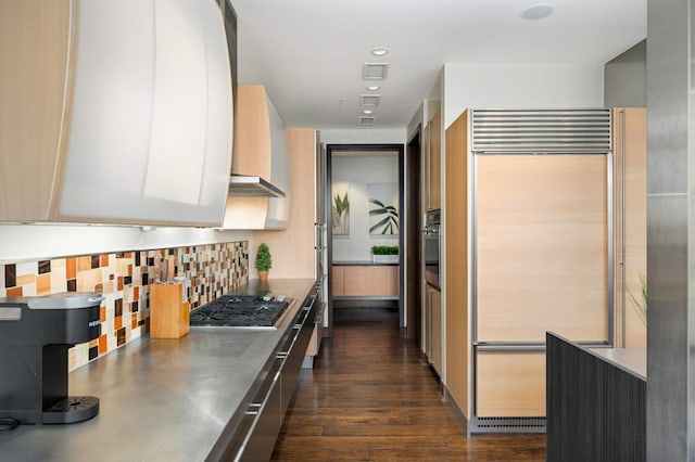 kitchen with backsplash, dark hardwood / wood-style flooring, white cabinetry, and stainless steel appliances