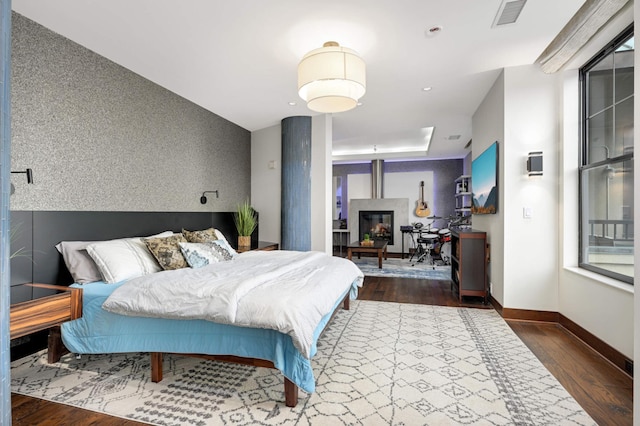317 Groveland Ave Unit 700, Minneapolis, MN 55403 - bedroom featuring wood finished floors and a glass covered fireplace