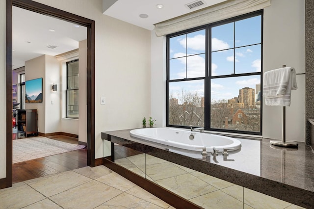 317 Groveland Ave Unit 700, Minneapolis, MN 55403 - bathroom featuring a garden tub, tile patterned flooring, and recessed lighting