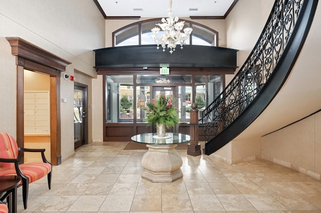 317 Groveland Ave Unit 700, Minneapolis, MN 55403 - entryway with a chandelier, crown molding, a high ceiling, and stairway