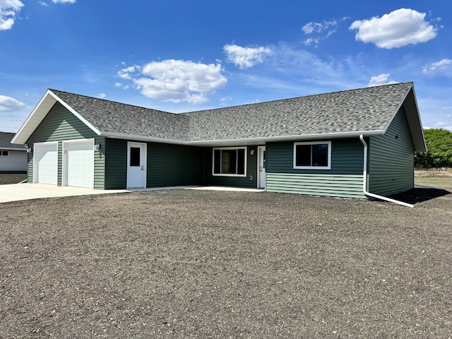 106 Front St, Tracy, MN 56175 - ranch-style house featuring roof with shingles, a garage, and concrete driveway