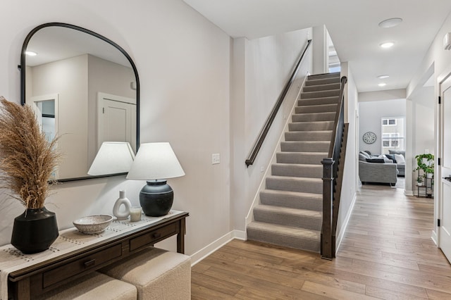 stairway with hardwood / wood-style floors