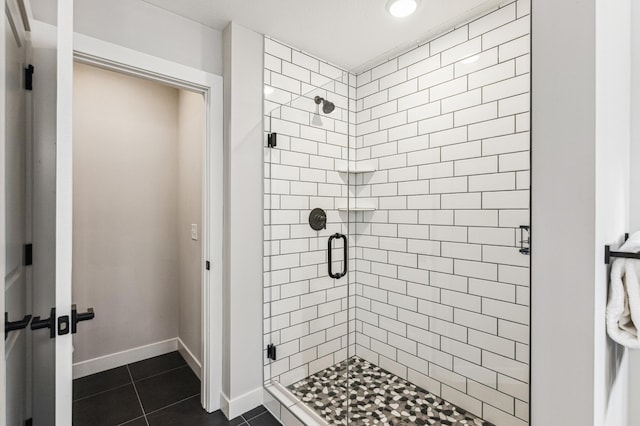 bathroom with tile patterned flooring and a shower with door