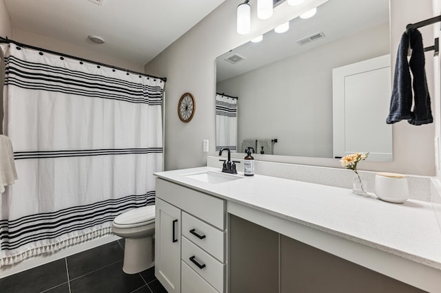 bathroom with vanity, toilet, and tile patterned flooring