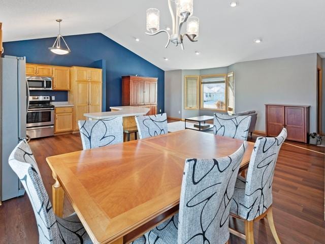 dining space with dark wood-type flooring, a notable chandelier, and vaulted ceiling