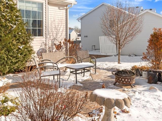 snow covered patio featuring an outdoor fire pit