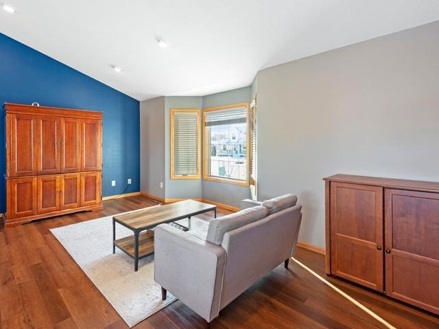 living room featuring vaulted ceiling and dark wood-type flooring