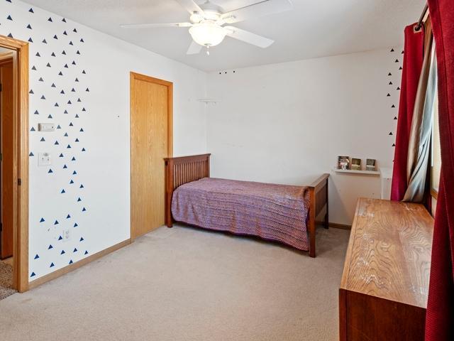 carpeted bedroom with ceiling fan