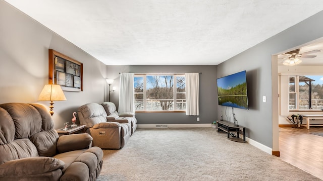 living room with carpet flooring and ceiling fan