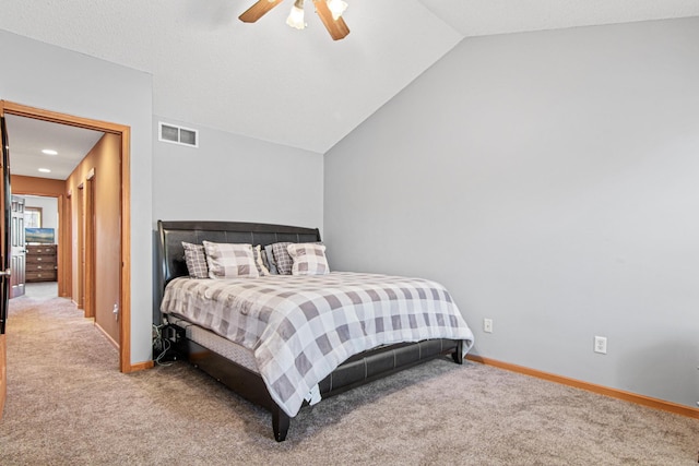 bedroom with vaulted ceiling, ceiling fan, and carpet flooring