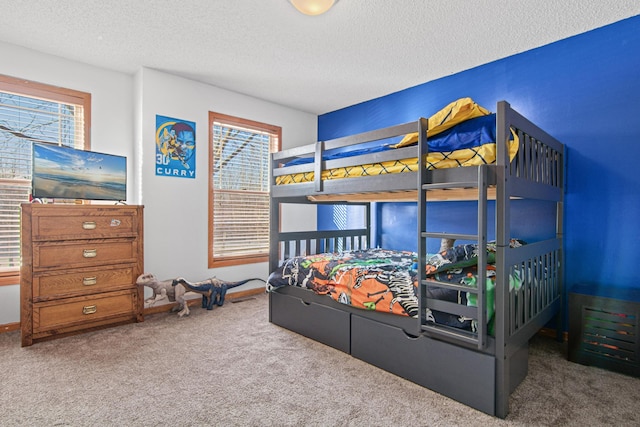 bedroom with a textured ceiling and carpet