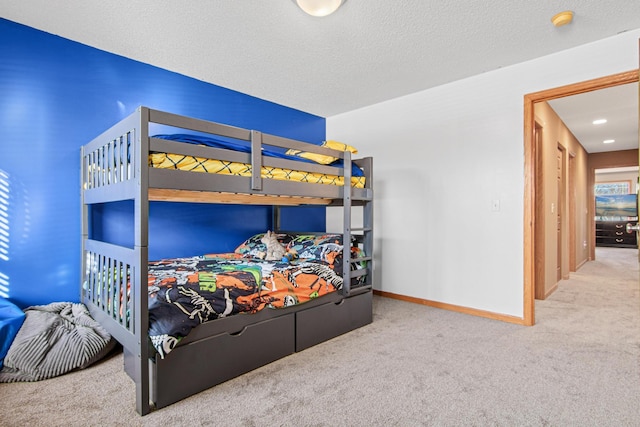 bedroom with carpet flooring and a textured ceiling