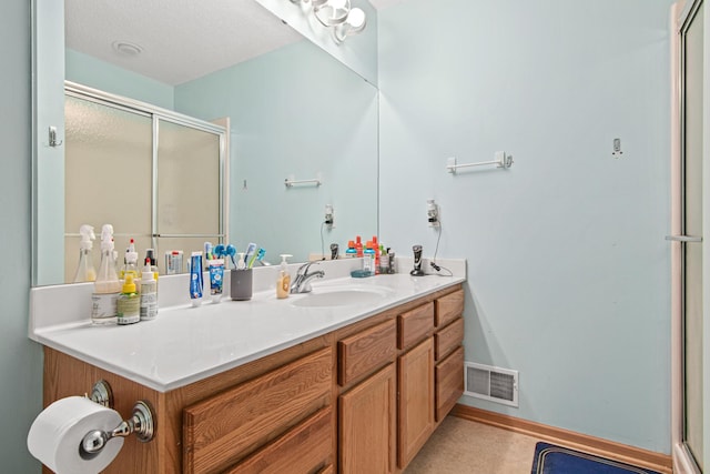 bathroom featuring vanity and an enclosed shower