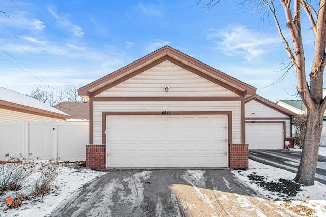 view of front of property featuring a garage and an outdoor structure