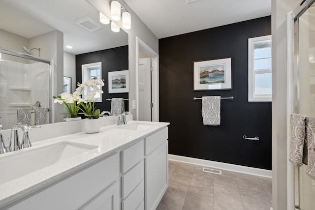 bathroom with tile patterned flooring, vanity, and a shower with shower door