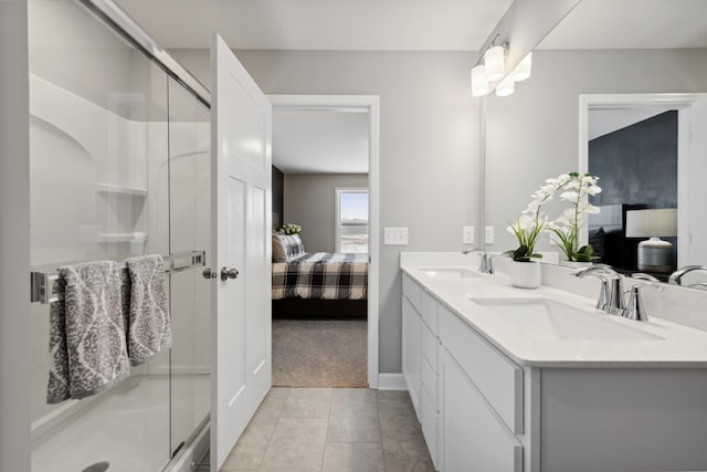 bathroom with an enclosed shower, vanity, and tile patterned floors