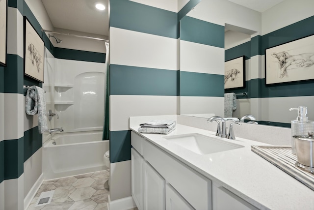 full bathroom featuring vanity, bathtub / shower combination, and toilet