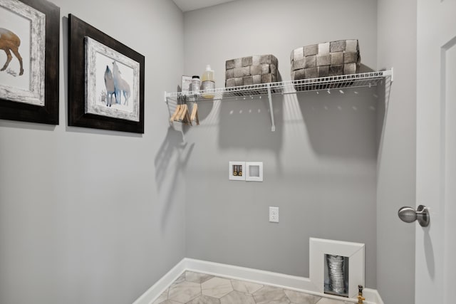 washroom featuring washer hookup and light tile patterned floors