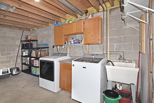 laundry room with cabinets, washer and dryer, and sink