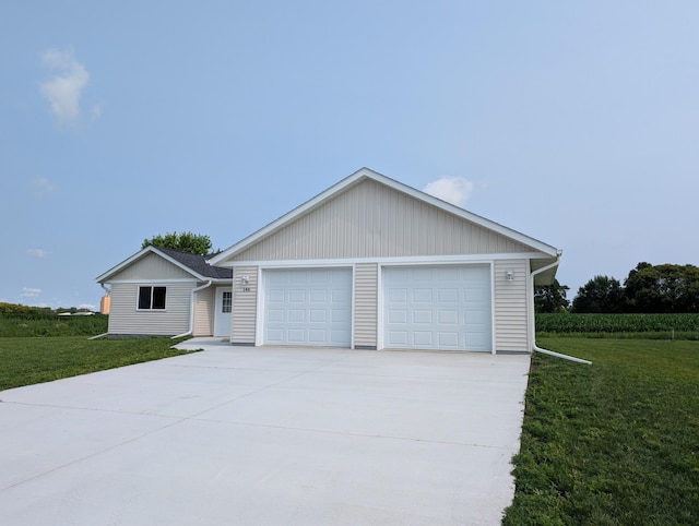 146 Front St, Tracy, MN 56175 - view of front of house with a front lawn, concrete driveway, and a garage