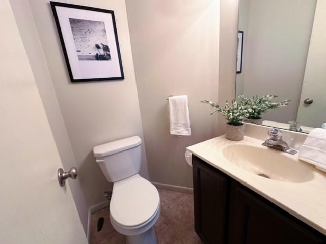 bathroom featuring tile patterned floors, vanity, and toilet