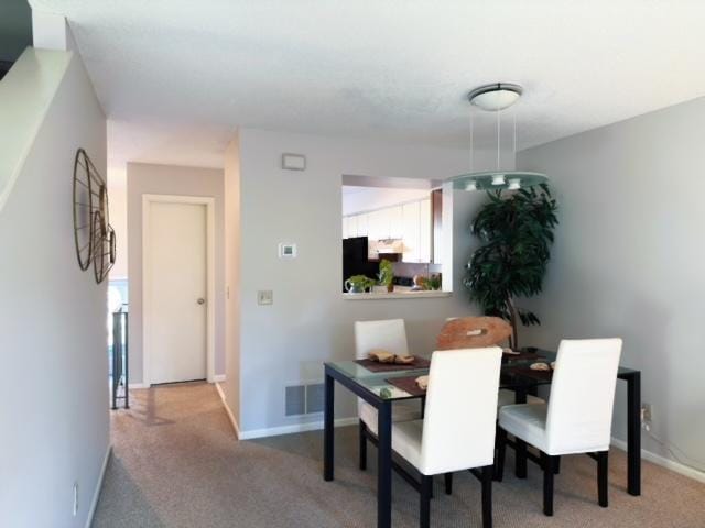 dining space with carpet