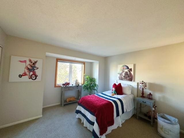 bedroom featuring carpet floors and a textured ceiling