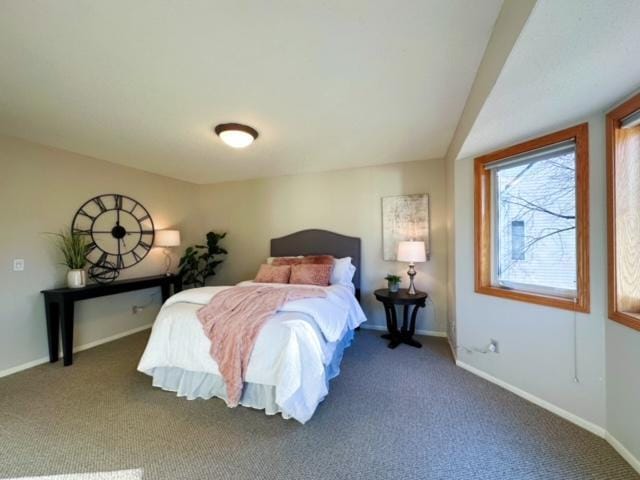 bedroom featuring dark colored carpet