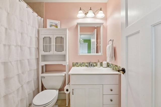 bathroom with toilet, vanity, and walk in shower