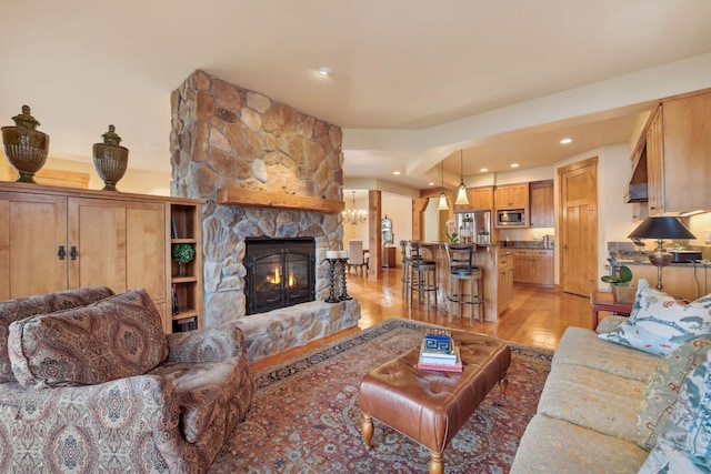 living room with a fireplace and light wood-type flooring