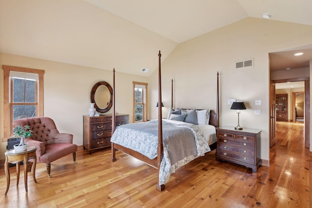 bedroom with wood-type flooring and vaulted ceiling