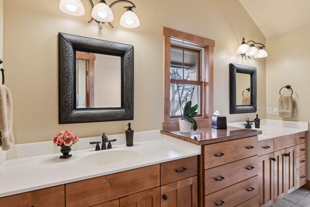 bathroom with vanity and lofted ceiling