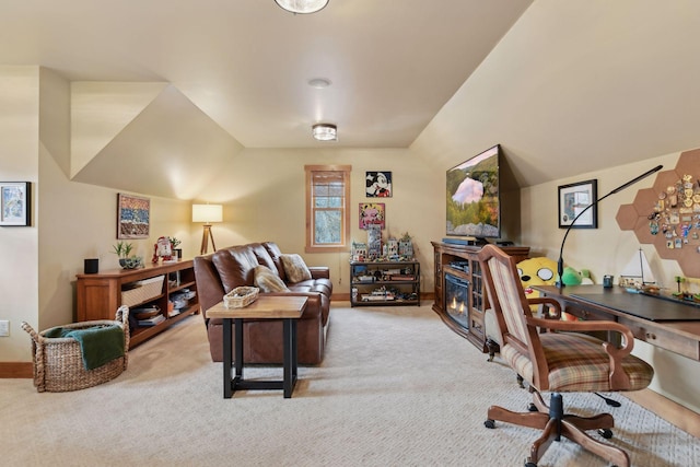 home office featuring light colored carpet and lofted ceiling