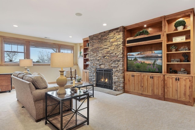 carpeted living room featuring built in shelves and a fireplace