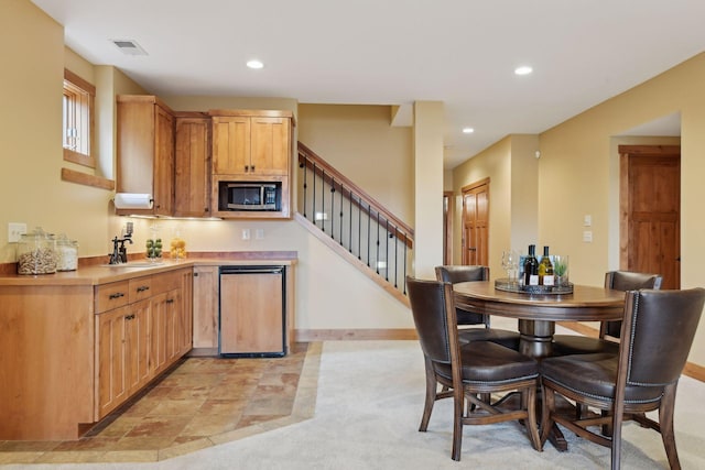 kitchen with sink, dishwashing machine, and built in microwave