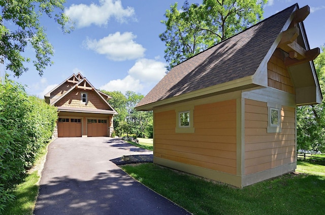 view of property exterior featuring a garage and an outdoor structure