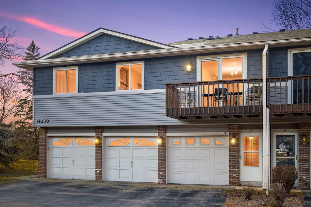 view of front facade with a balcony and a garage