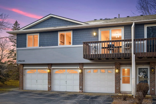 view of front facade with a balcony and a garage