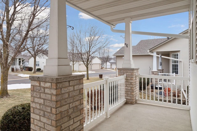 view of patio / terrace with a residential view and a porch