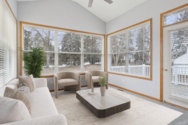 sunroom / solarium featuring a ceiling fan, lofted ceiling, a healthy amount of sunlight, and visible vents