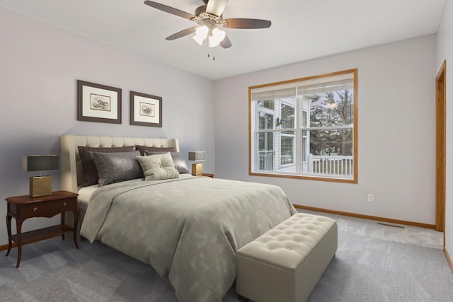 carpeted bedroom featuring visible vents, baseboards, and a ceiling fan