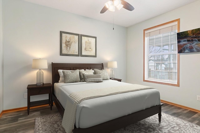 bedroom with baseboards, wood finished floors, and a ceiling fan